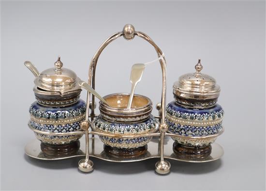 A Doulton Lambeth three piece cruet set, with plated mounts and frame, dated 1880, total width 19.5cm